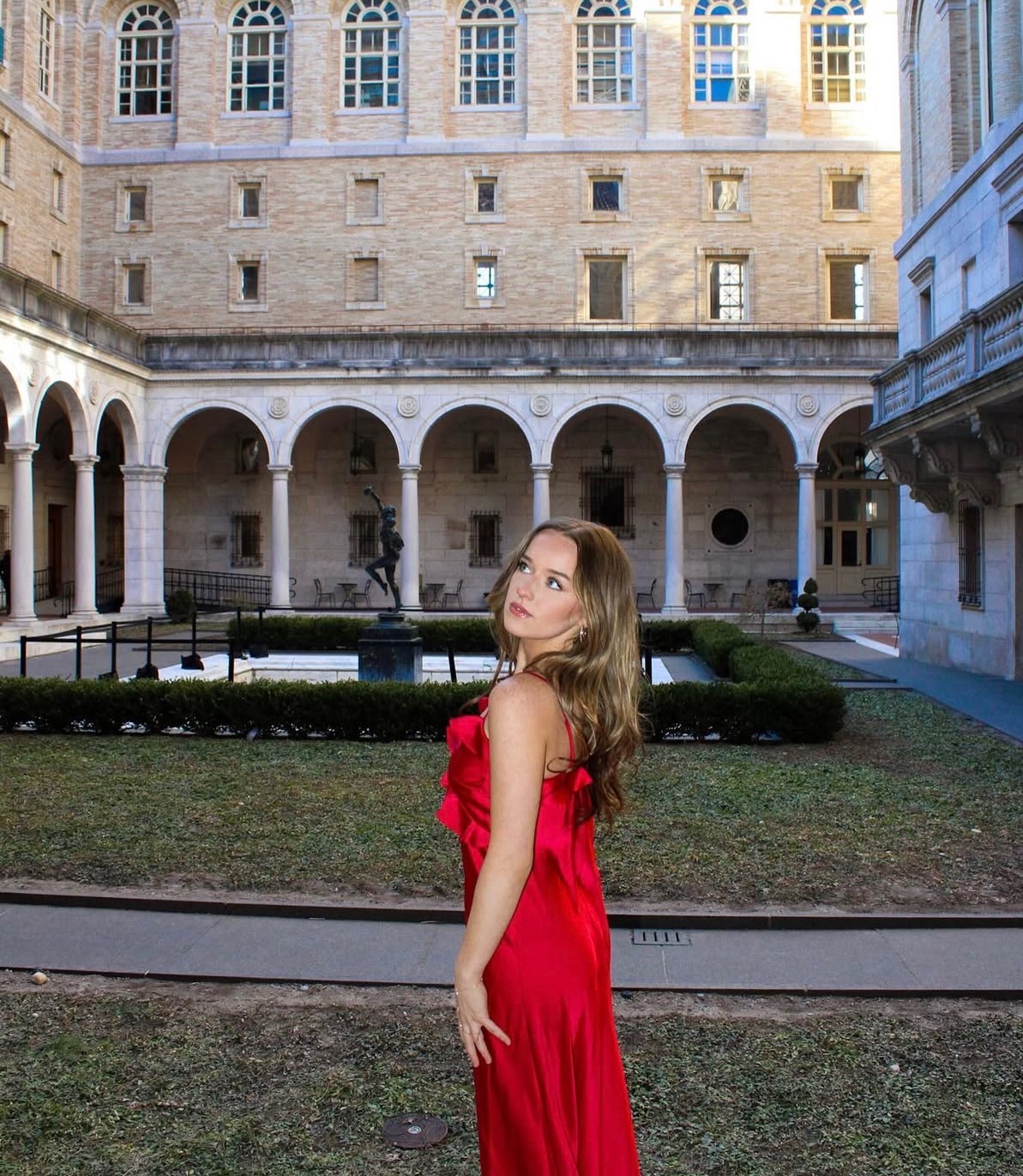 Portrait in a red dress at the Boston Public Library courtyard