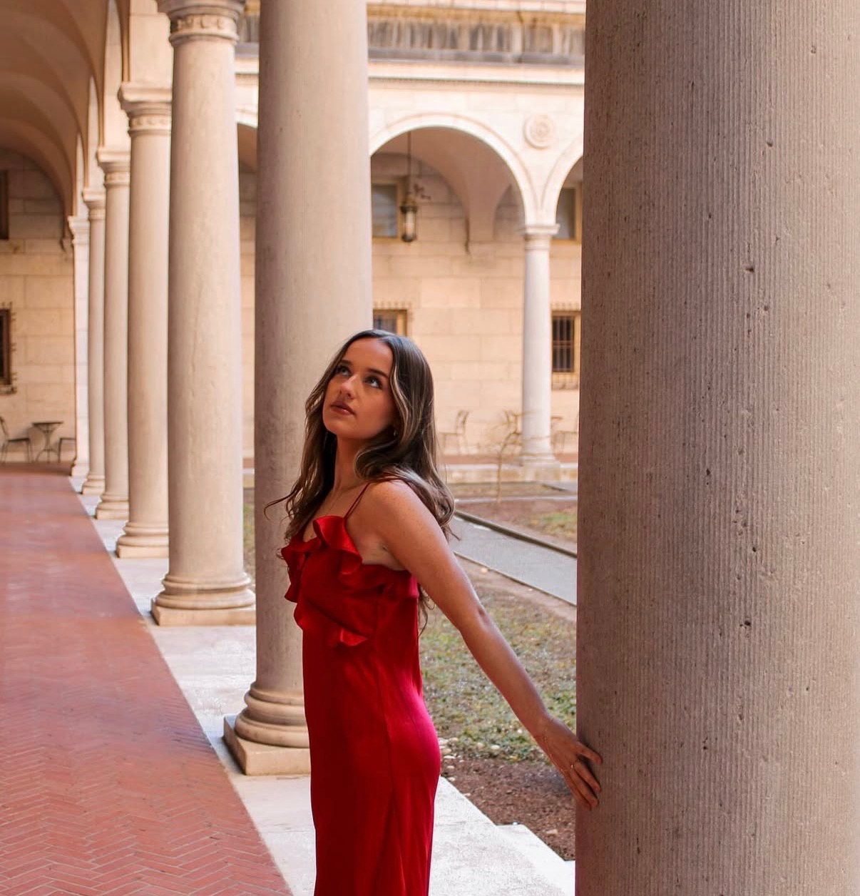 Portrait in a red dress among the columns of the Boston Public Library