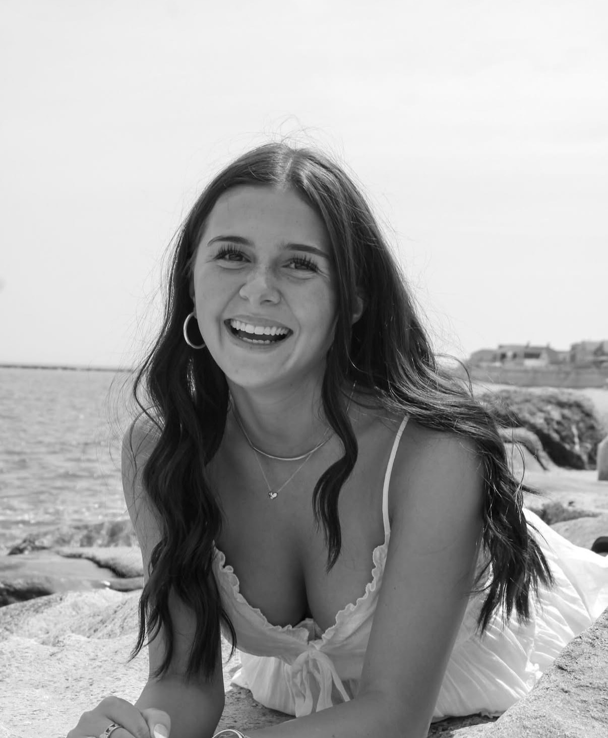Black and white summer portrait laughing by the coast
